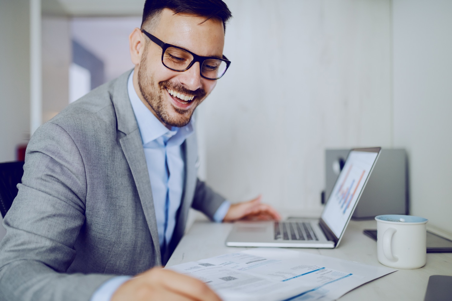 Credit manager reviewing a past due business account statement before placing it with a commercial collection agency